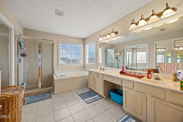 a spacious bathroom with a sink a large mirror and a bathtub