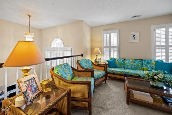 a living room with furniture and a chandelier