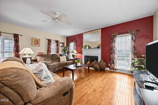 a living room with furniture a fireplace and a flat screen tv