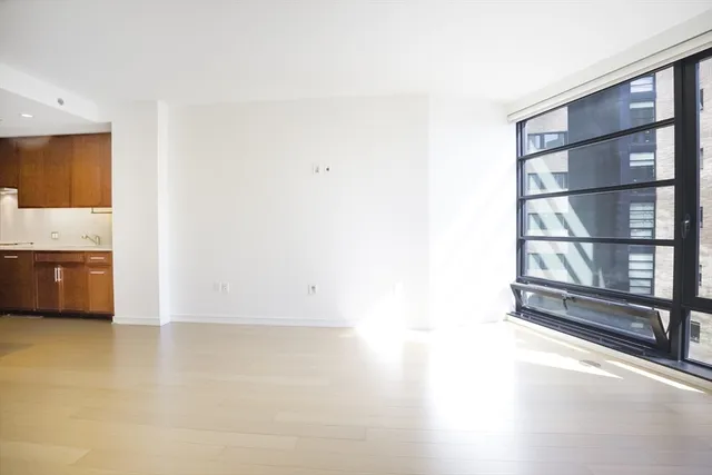 a view of an empty room with a cabinet