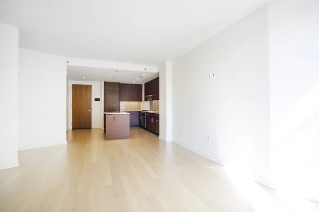 a view of a room with a sink and cabinets