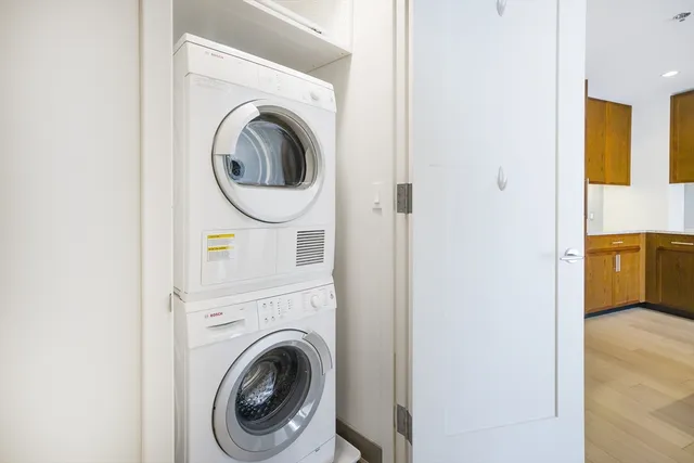 a view of a bedroom with washer and dryer