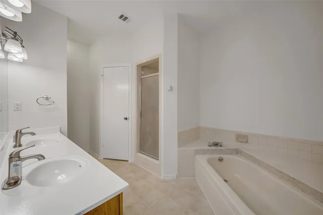 a bathroom with a tub sink and mirror