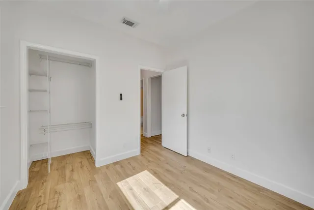 a view of an empty room and wooden floor