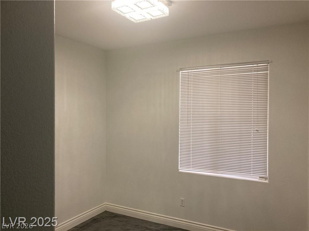 9050 West Warm Springs Road, Unit 1027 Las Vegas, NV 89148 - Photo 19 of 44 Well-lit room with modern flush-mount lighting and clean, durable flooring.