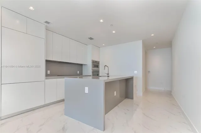 a view of kitchen with cabinets