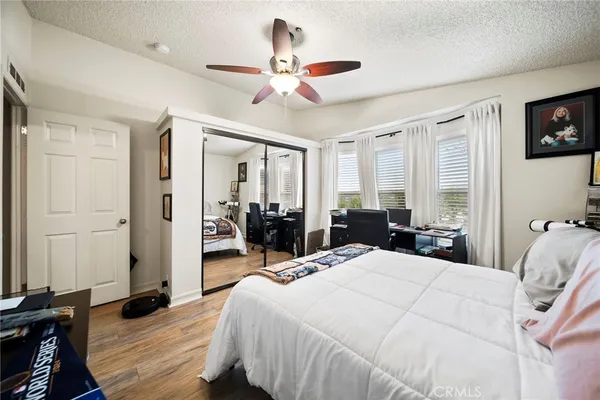 a bedroom with a bed and wooden floor