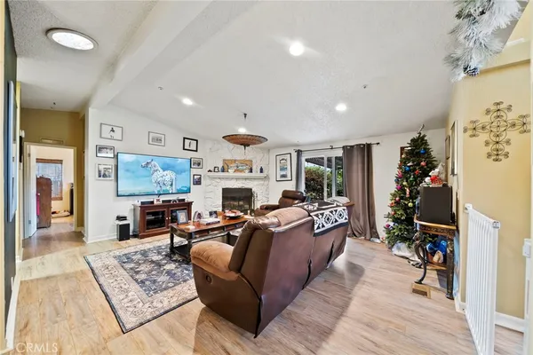 a living room with furniture a fireplace and a flat screen tv