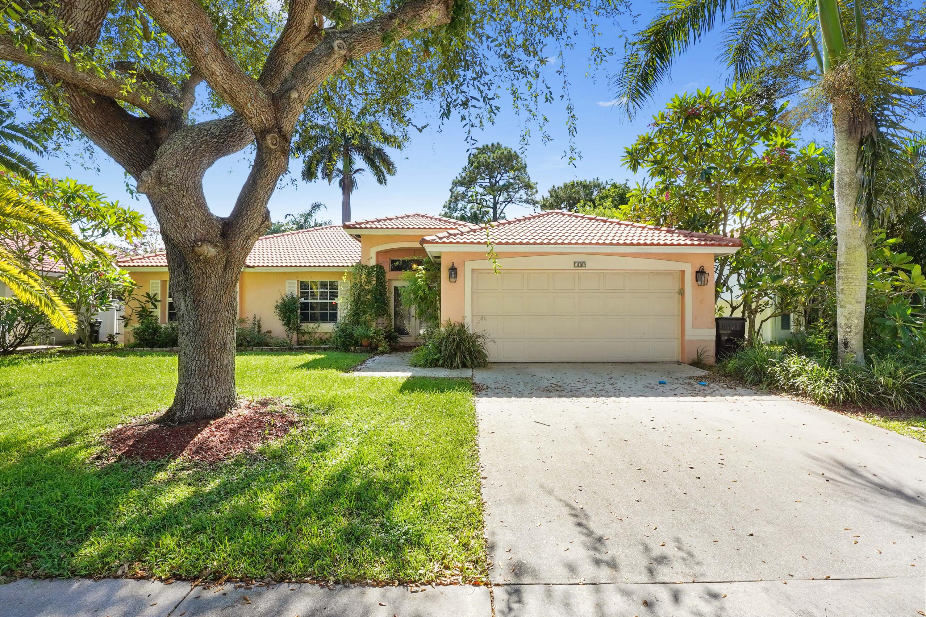132 West Lee Road Delray Beach, FL 33445 - Photo 1 of 41 a front view of a house with garden