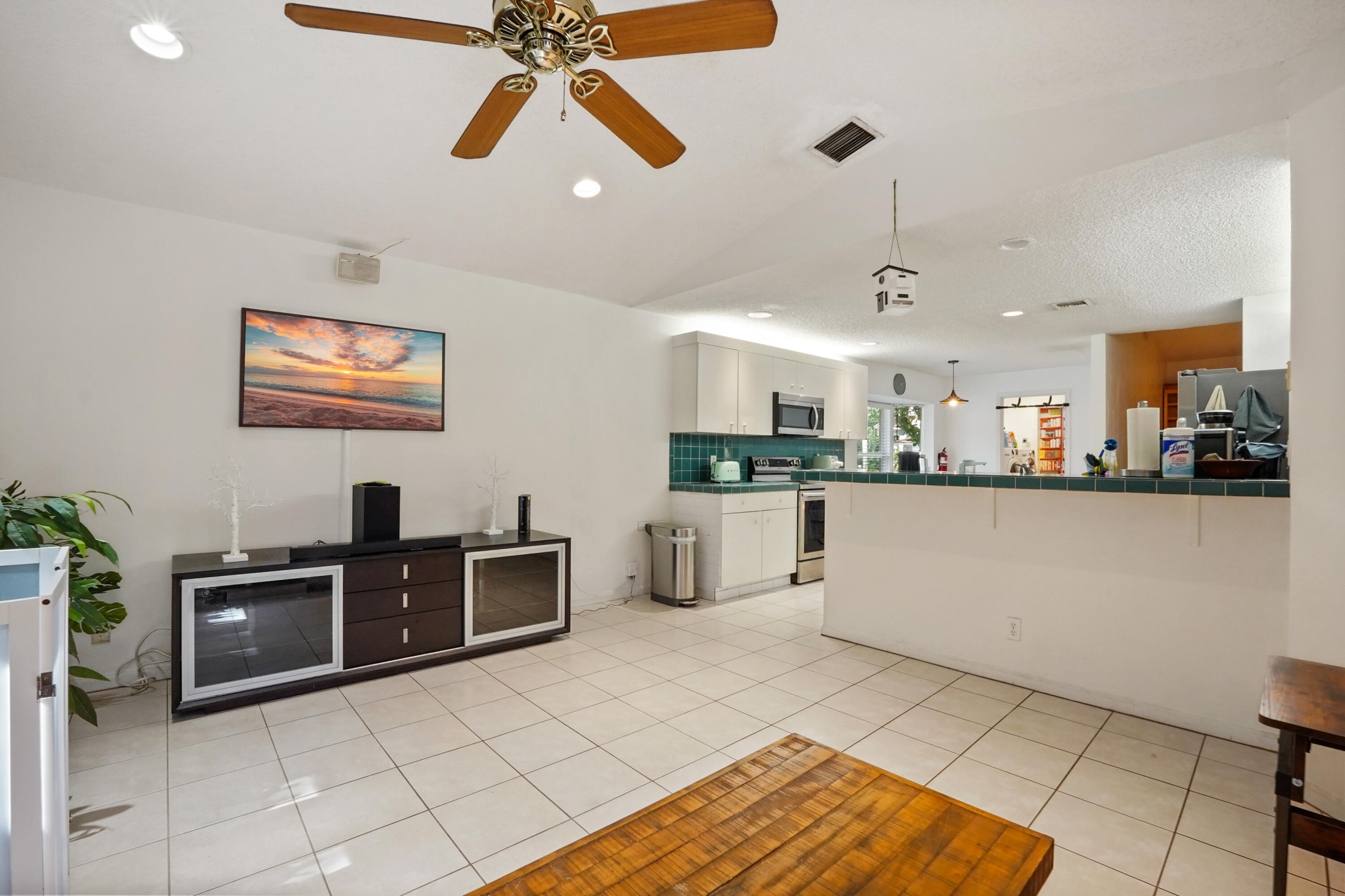 132 West Lee Road Delray Beach, FL 33445 - Photo 15 of 41 a kitchen with stainless steel appliances kitchen island granite countertop a refrigerator a stove and a sink with granite countertops