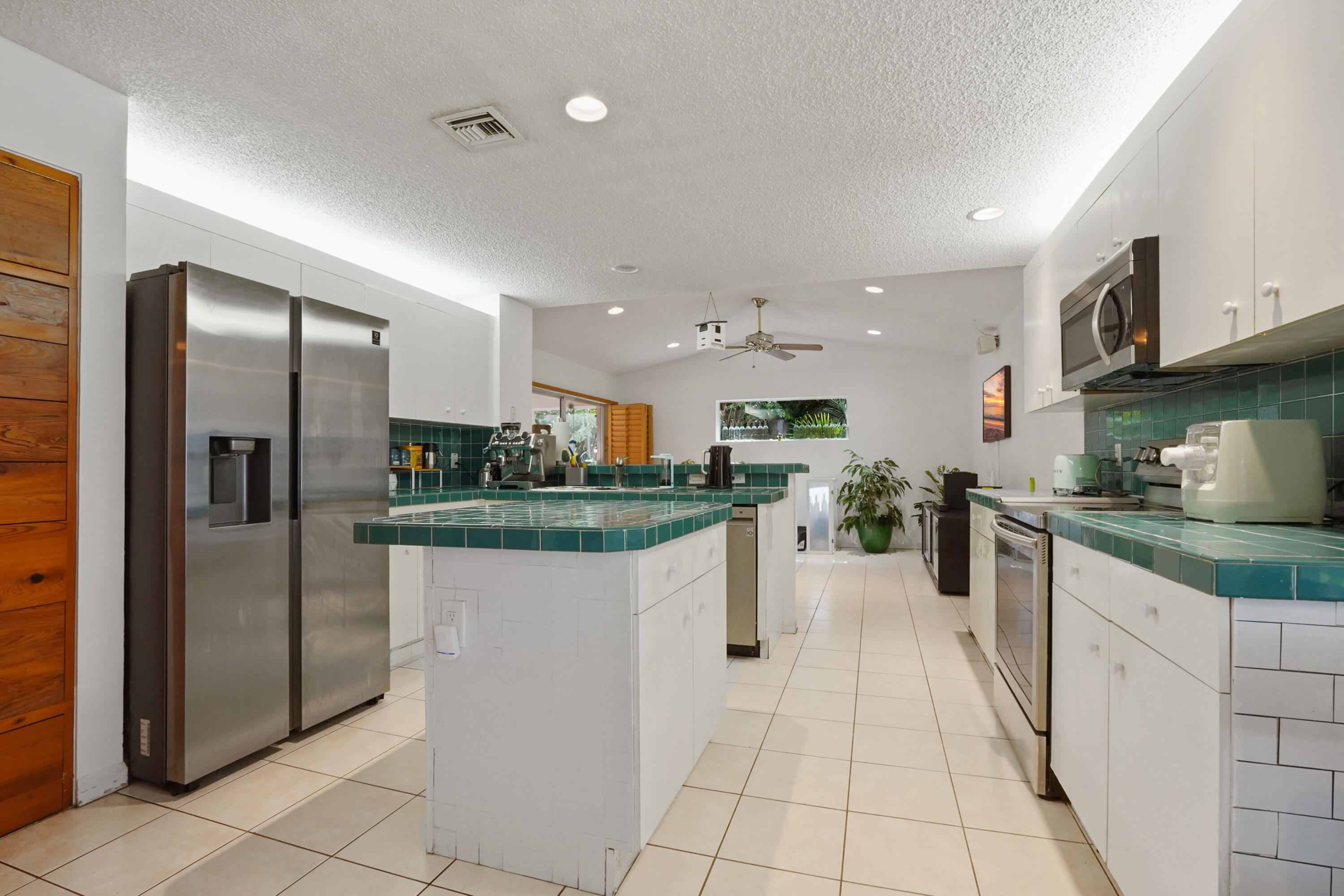 132 West Lee Road Delray Beach, FL 33445 - Photo 19 of 41 a kitchen with stainless steel appliances granite countertop a refrigerator and a sink