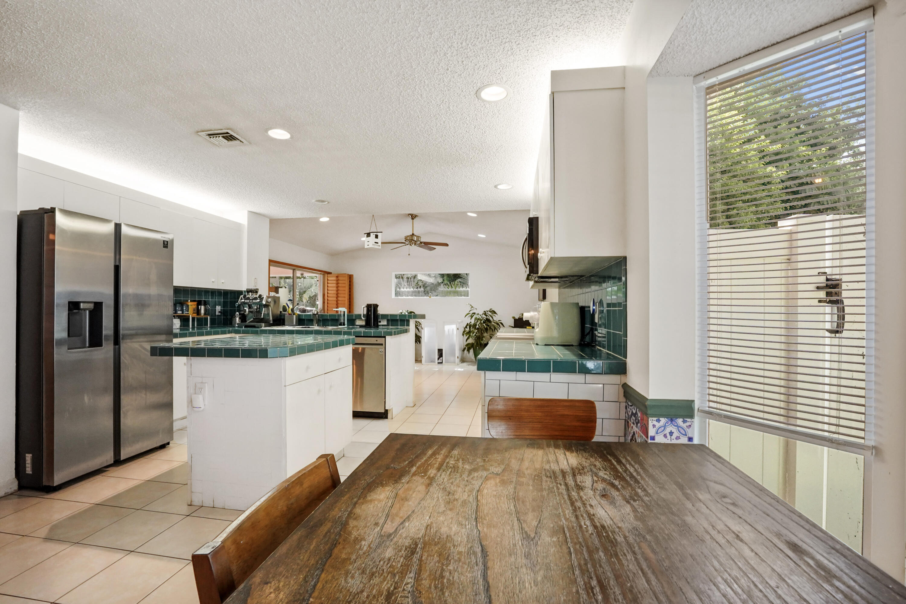 132 West Lee Road Delray Beach, FL 33445 - Photo 22 of 41 a kitchen with a refrigerator and a stove top oven