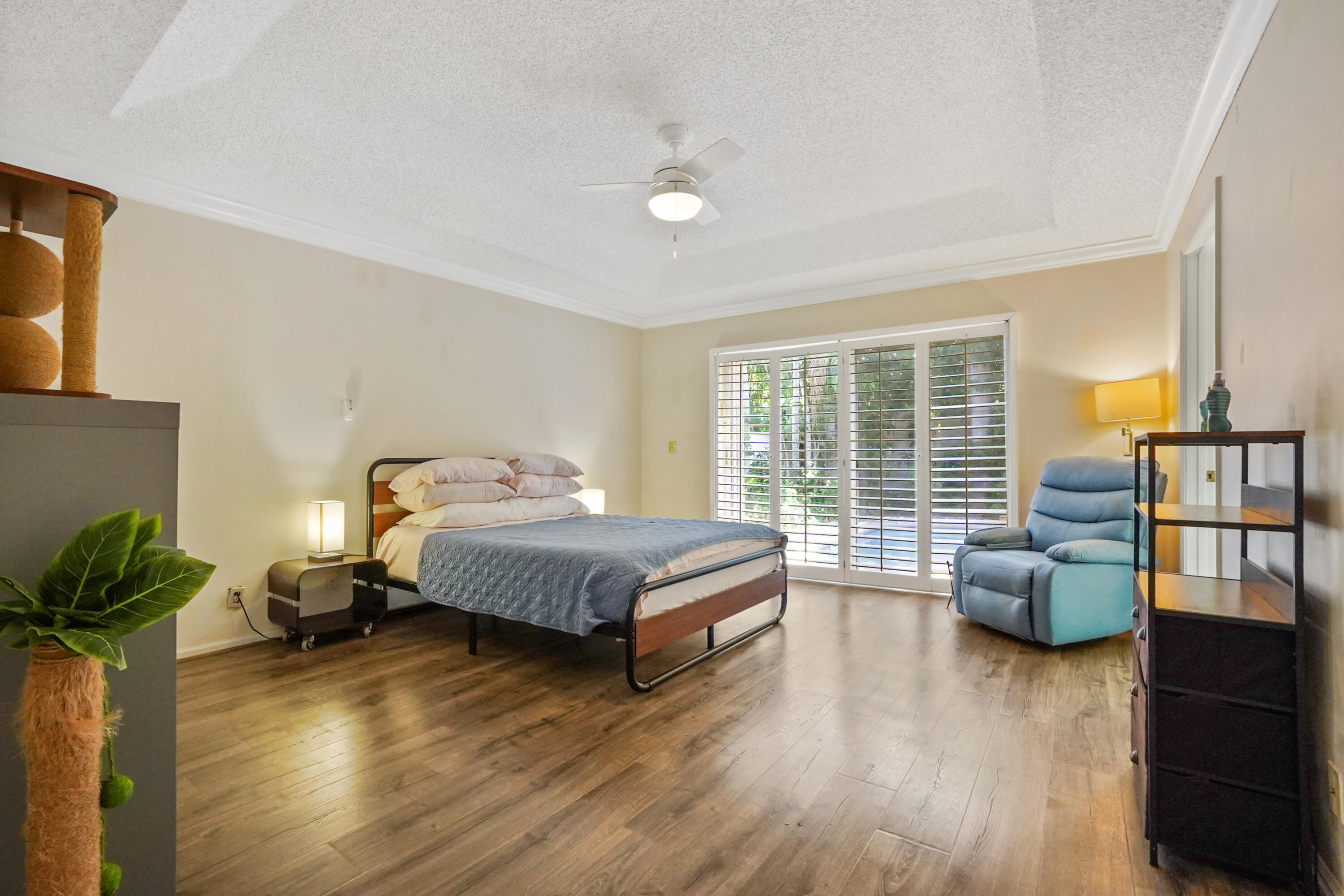 132 West Lee Road Delray Beach, FL 33445 - Photo 24 of 41 a spacious bedroom with a bed and wooden floor