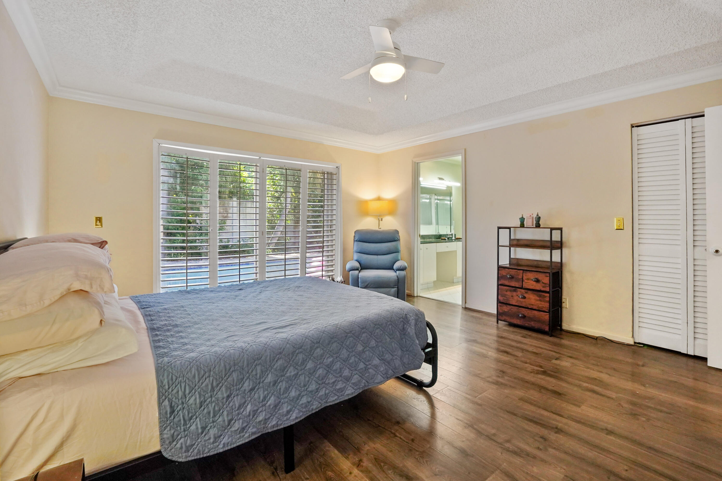 132 West Lee Road Delray Beach, FL 33445 - Photo 25 of 41 a spacious bedroom with a bed and wooden floor