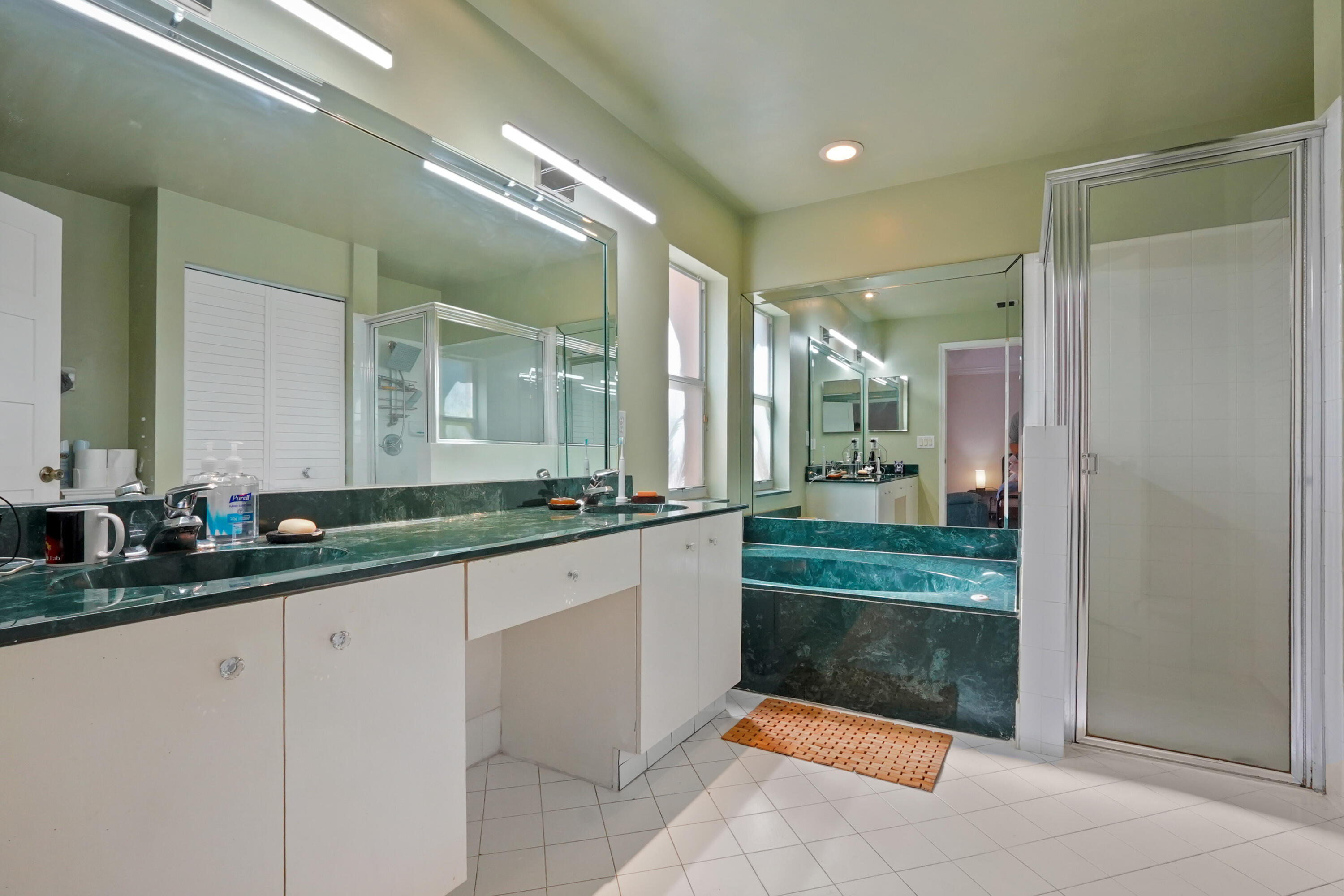132 West Lee Road Delray Beach, FL 33445 - Photo 27 of 41 a large bathroom with a large mirror vanity and a shower
