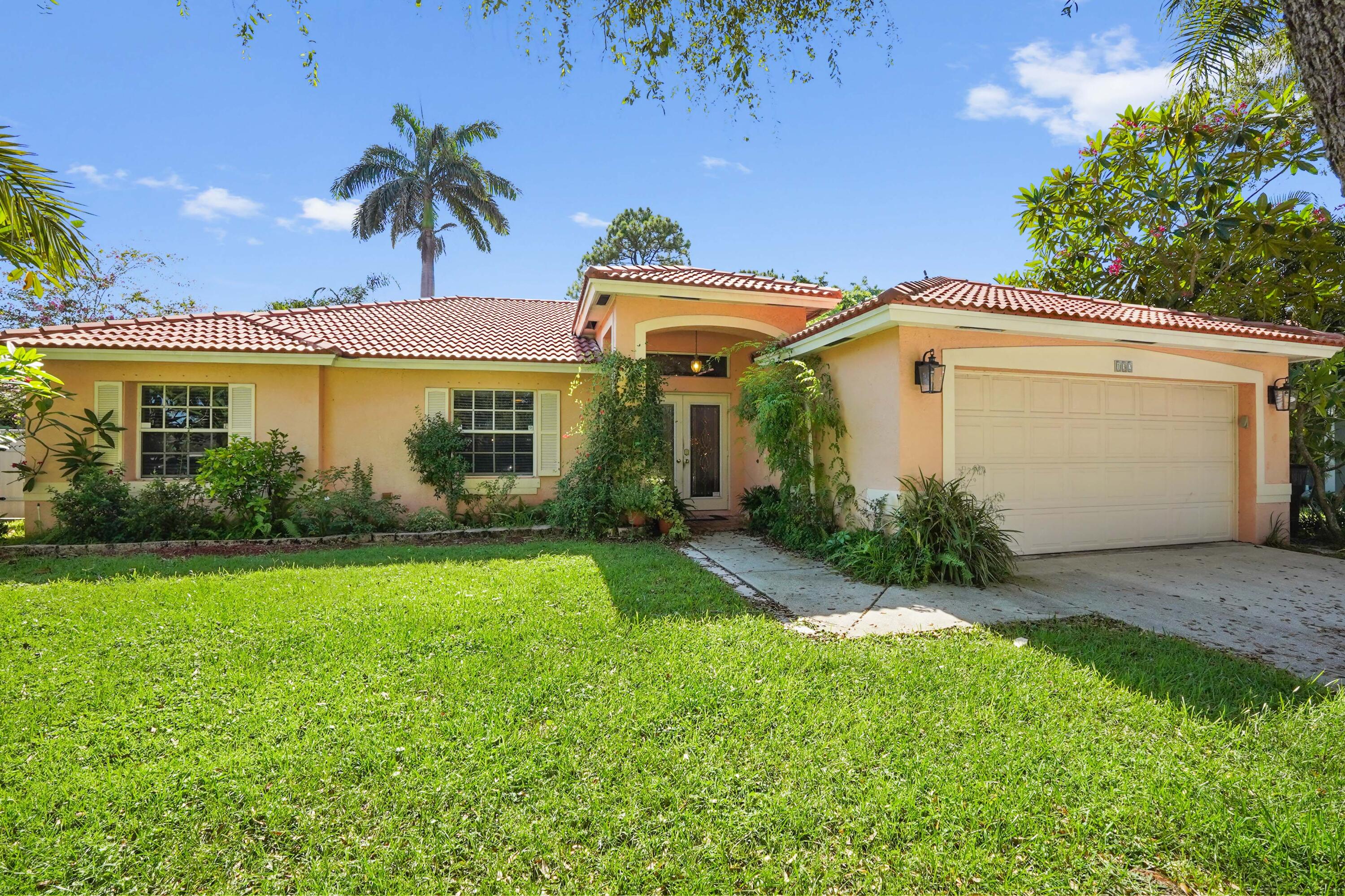 132 West Lee Road Delray Beach, FL 33445 - Photo 4 of 41 a view of a house with a yard and potted plants