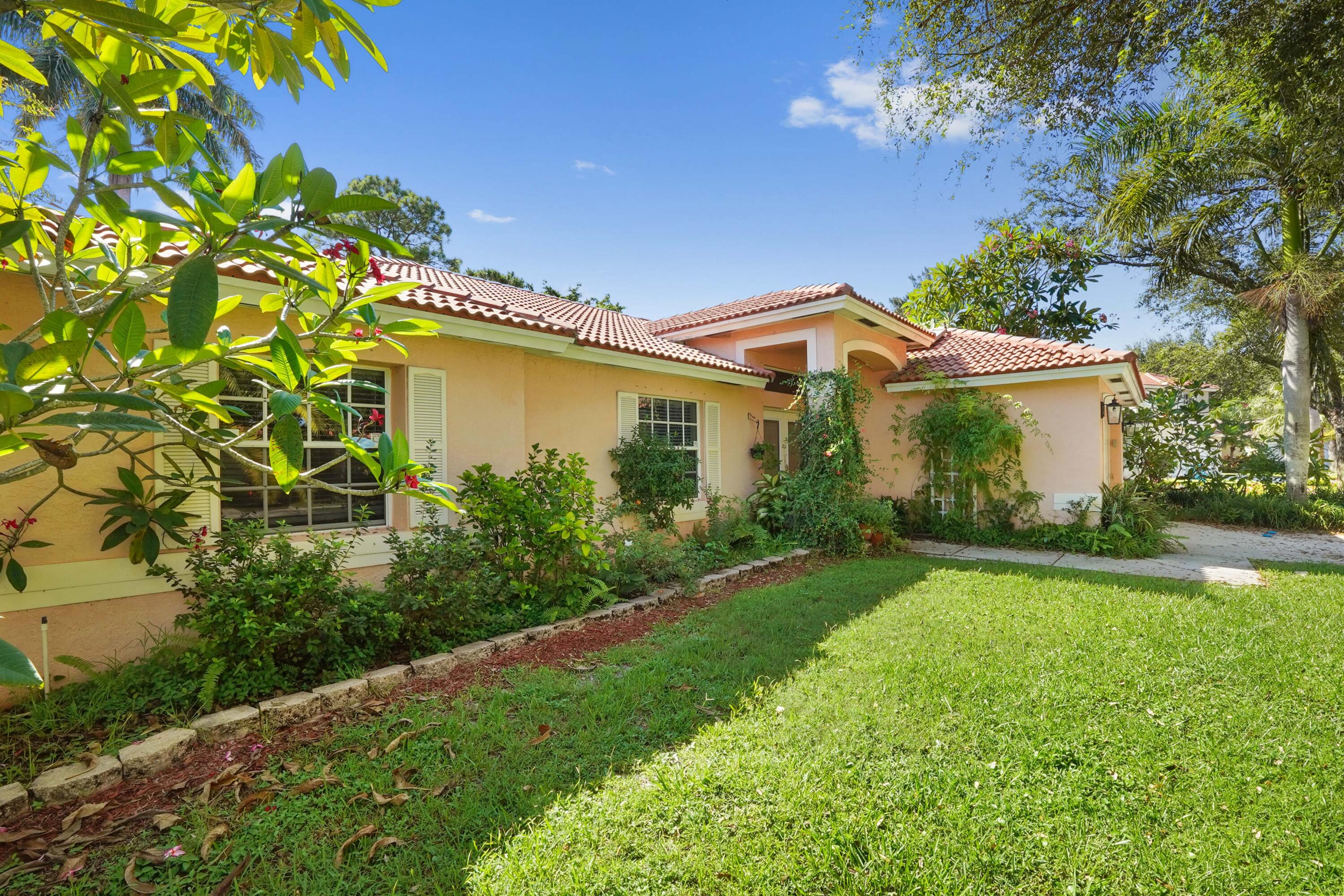 132 West Lee Road Delray Beach, FL 33445 - Photo 5 of 41 a front view of a house with garden