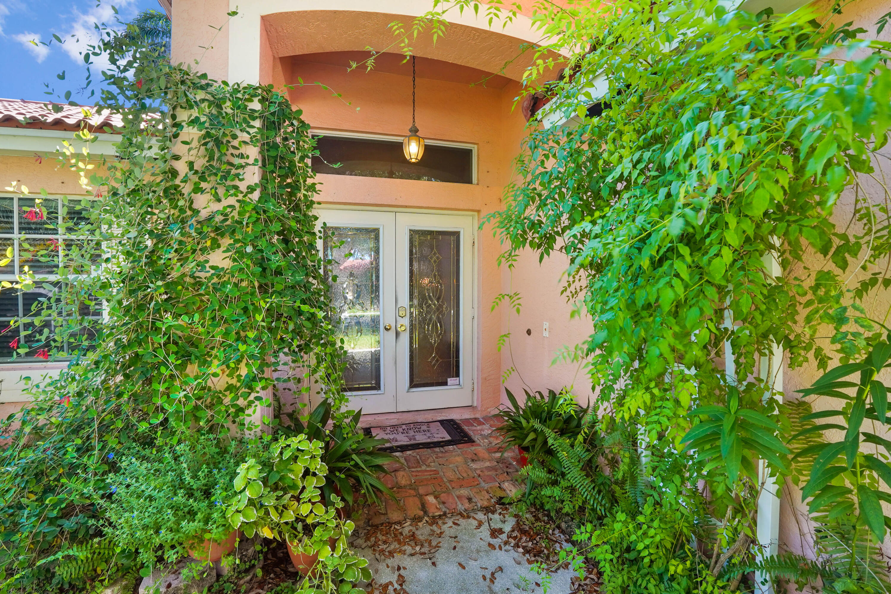 132 West Lee Road Delray Beach, FL 33445 - Photo 6 of 41 a front view of a house with a garden
