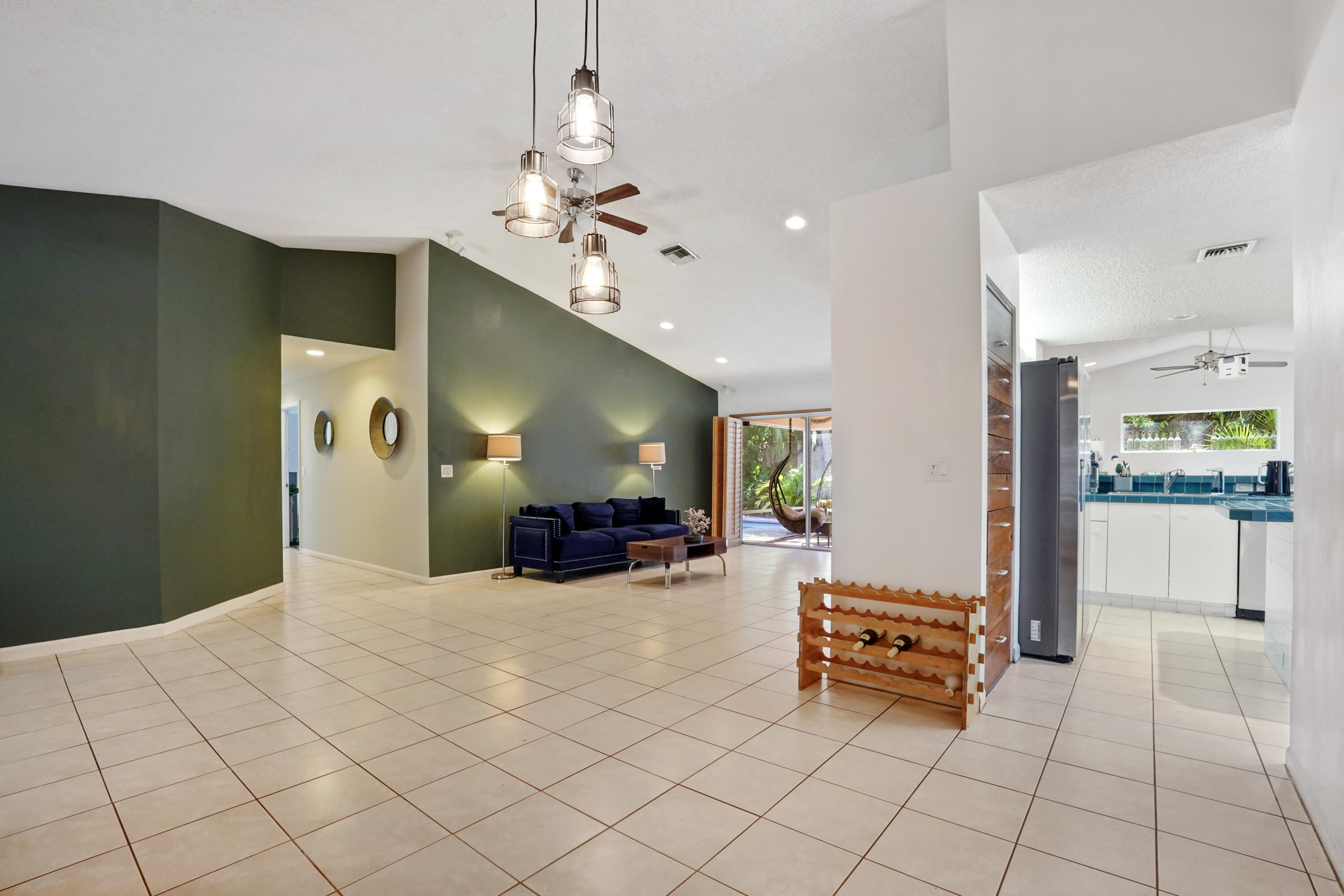 132 West Lee Road Delray Beach, FL 33445 - Photo 8 of 41 a living room with furniture and a chandelier
