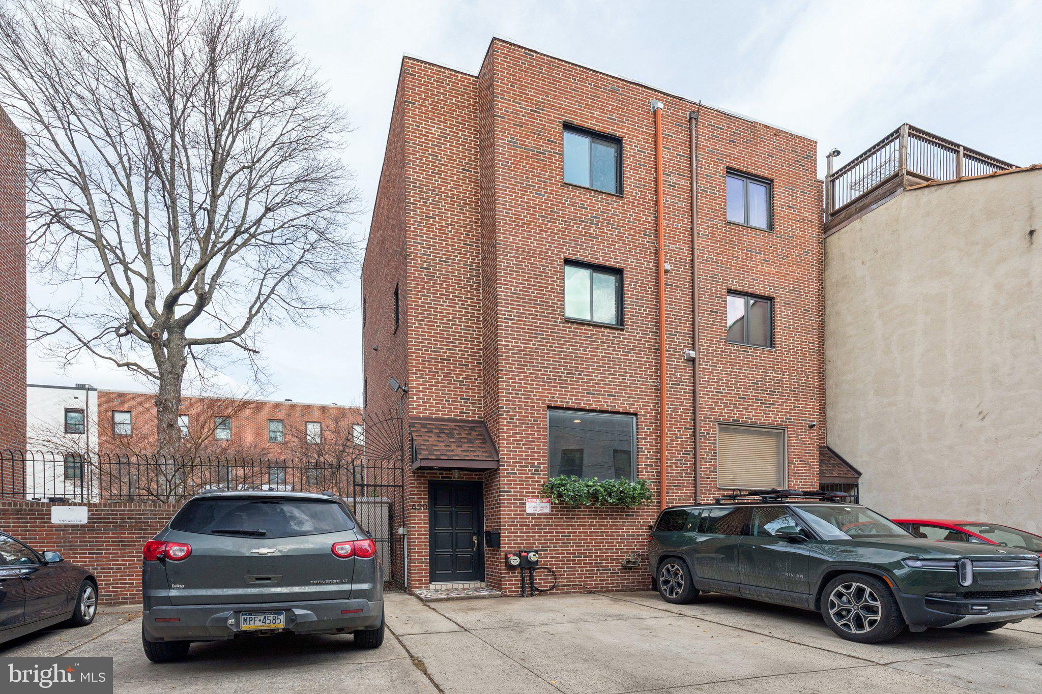 a car parked in front of a brick house