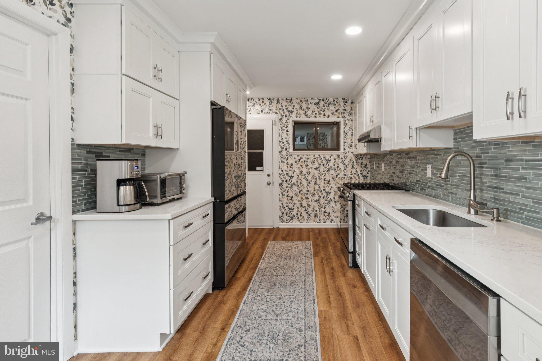 429 Gaskill Street Philadelphia, PA 19147 - Photo 13 of 63 a kitchen with stainless steel appliances granite countertop a sink and a stove