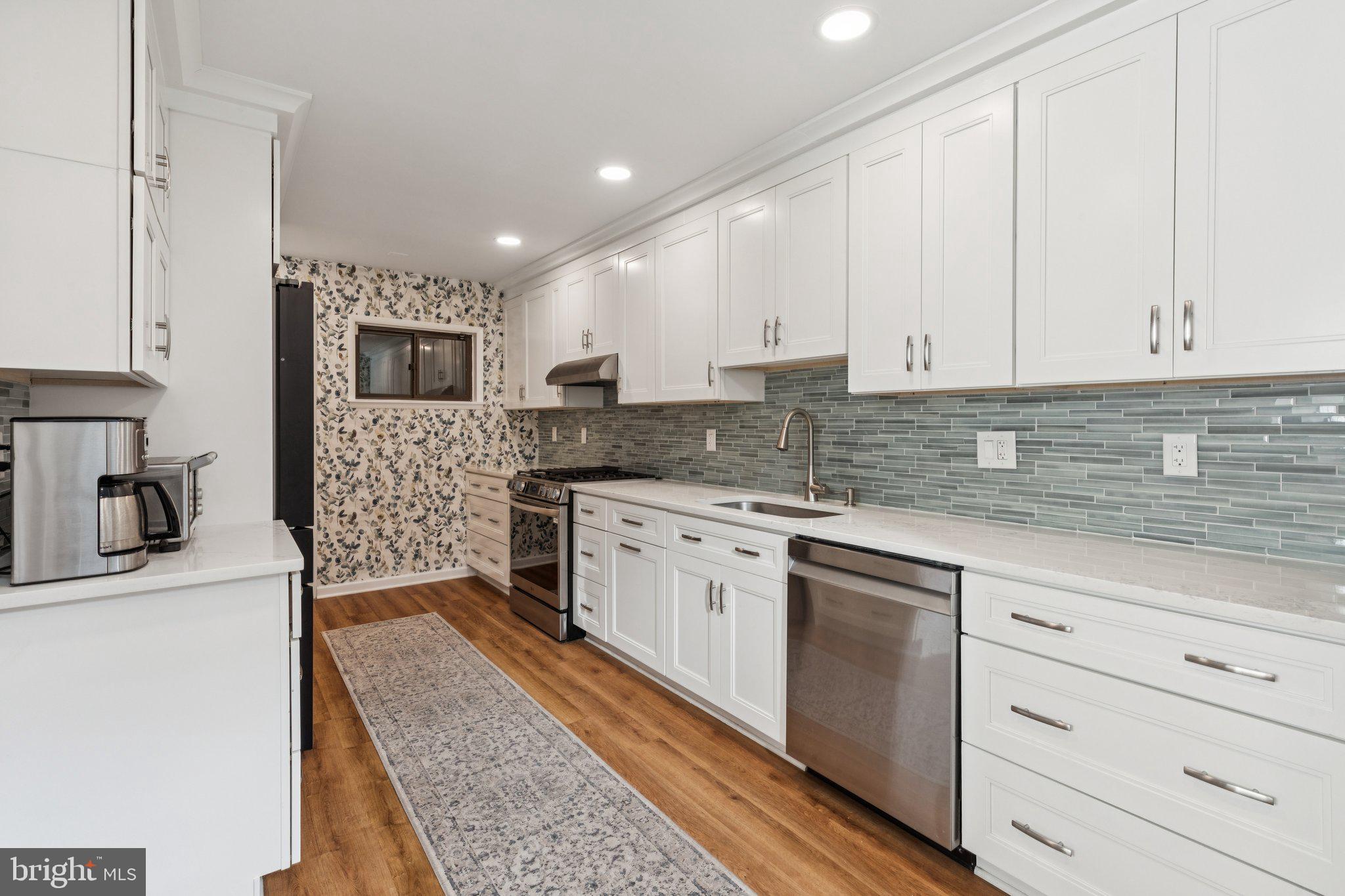 429 Gaskill Street Philadelphia, PA 19147 - Photo 14 of 63 a kitchen with granite countertop a sink stove and cabinets