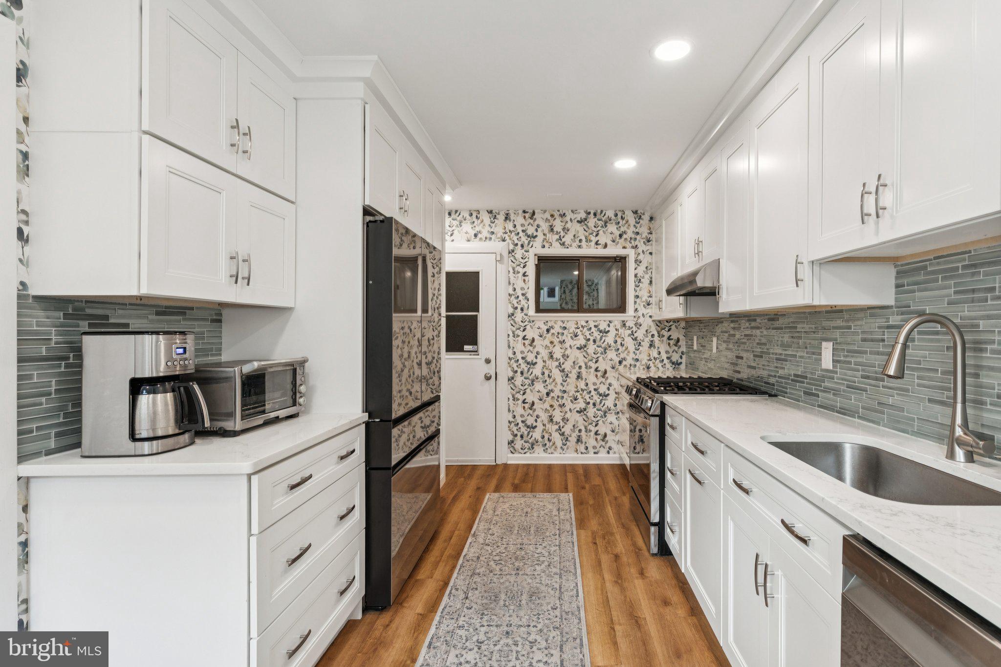 429 Gaskill Street Philadelphia, PA 19147 - Photo 15 of 63 a kitchen with stainless steel appliances kitchen island granite countertop a sink stove and refrigerator