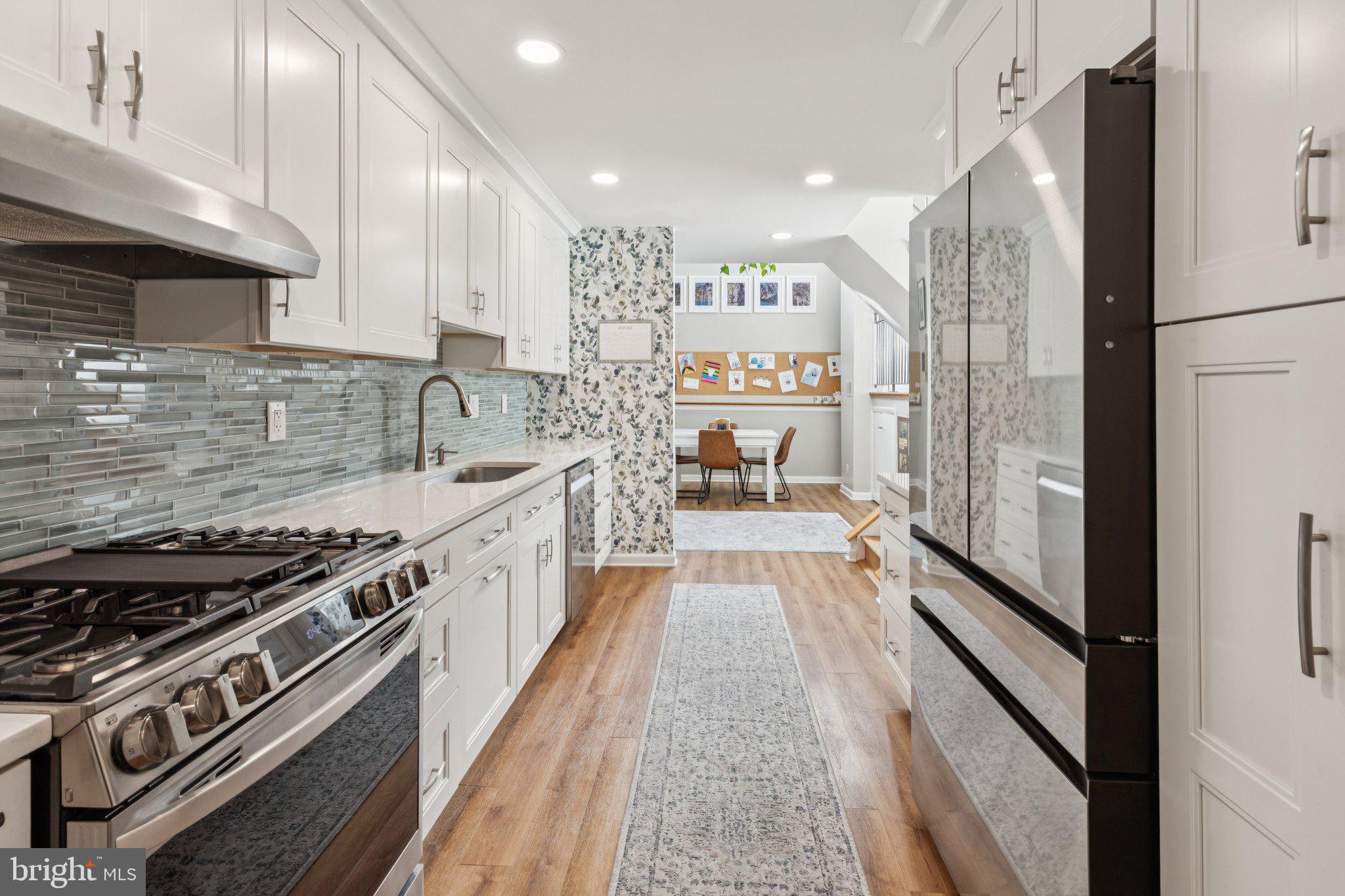 429 Gaskill Street Philadelphia, PA 19147 - Photo 17 of 63 a large kitchen with stainless steel appliances granite countertop a stove and a refrigerator