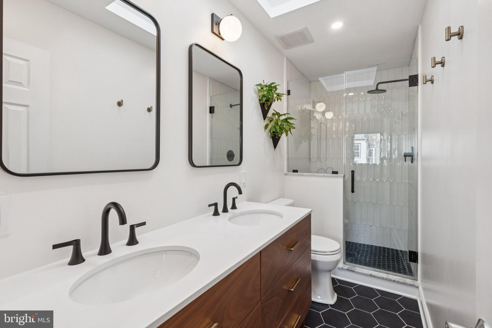 429 Gaskill Street Philadelphia, PA 19147 - Photo 54 of 63 a bathroom with a double vanity sink mirror and shower