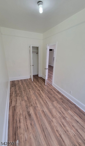569 Morris Street Orange, NJ 07050 - Photo 3 of 10 a view of a room with wooden floor and white walls