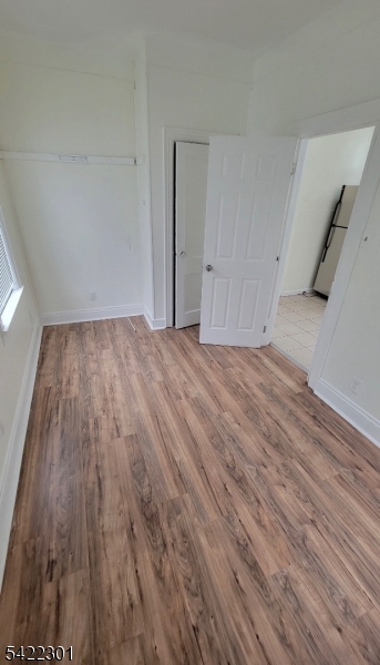 569 Morris Street Orange, NJ 07050 - Photo 5 of 10 a view of an empty room with wooden floor