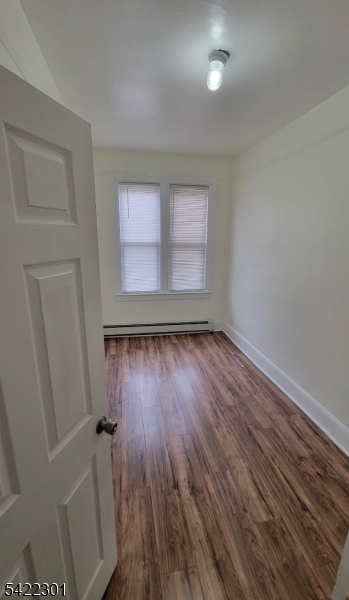 569 Morris Street Orange, NJ 07050 - Photo 6 of 10 an empty room with wooden floor and windows