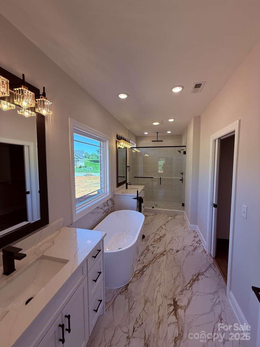 4173 Holly Circle Northeast Conover, NC 28613 - Photo 15 of 40 a bathroom with a granite countertop sink a mirror and a bathtub