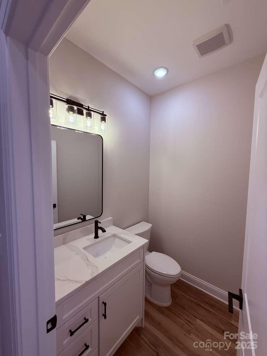 4173 Holly Circle Northeast Conover, NC 28613 - Photo 24 of 40 a bathroom with a granite countertop sink a toilet and a mirror