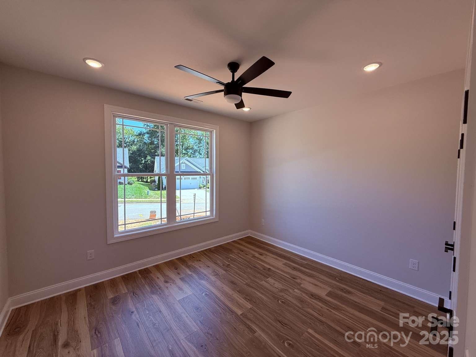 4173 Holly Circle Northeast Conover, NC 28613 - Photo 26 of 40 wooden floor in an empty room with a window