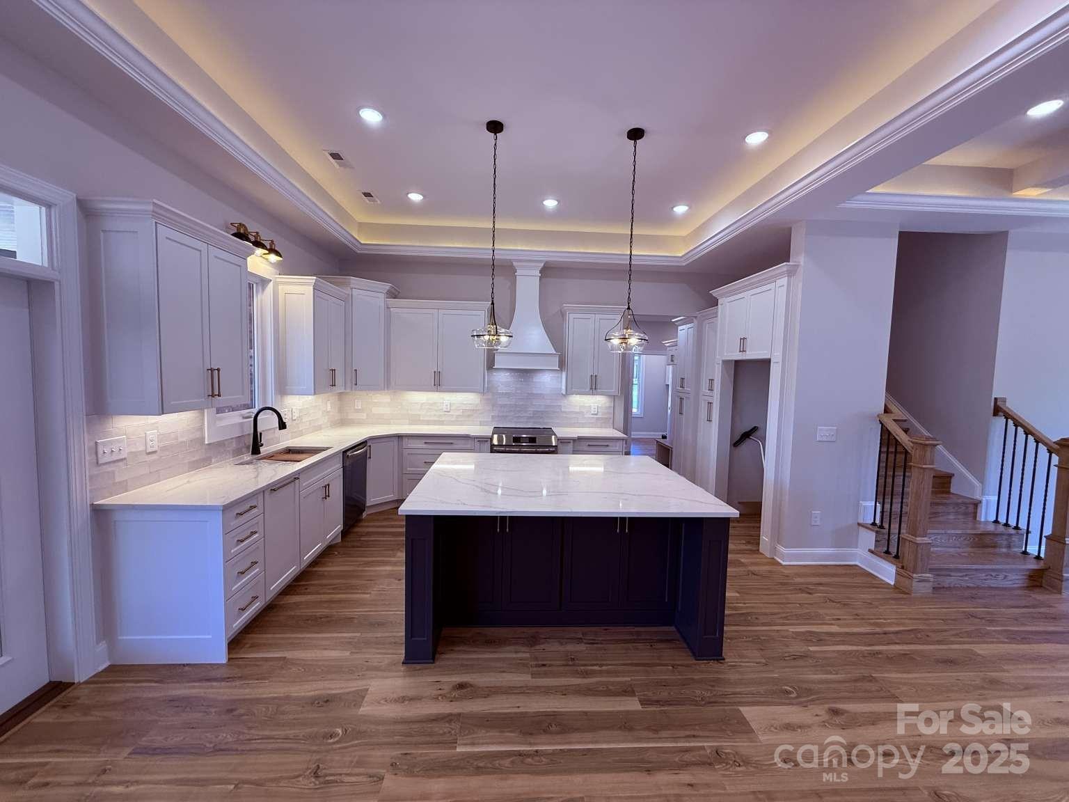 4173 Holly Circle Northeast Conover, NC 28613 - Photo 5 of 40 a large white kitchen with a sink stainless steel appliances and cabinets