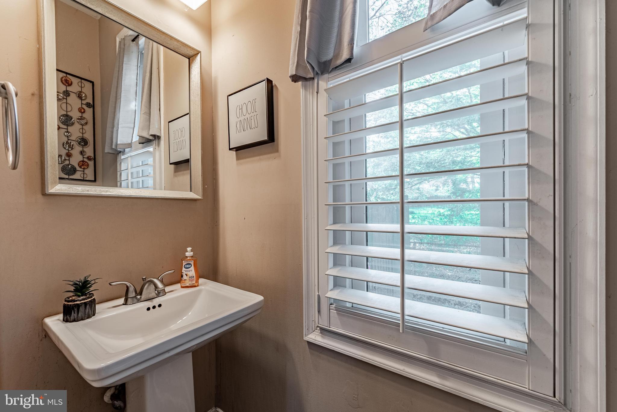 2600 Queen Anne Road Baltimore, MD 21216 - Photo 13 of 28 a bathroom with a sink and a mirror