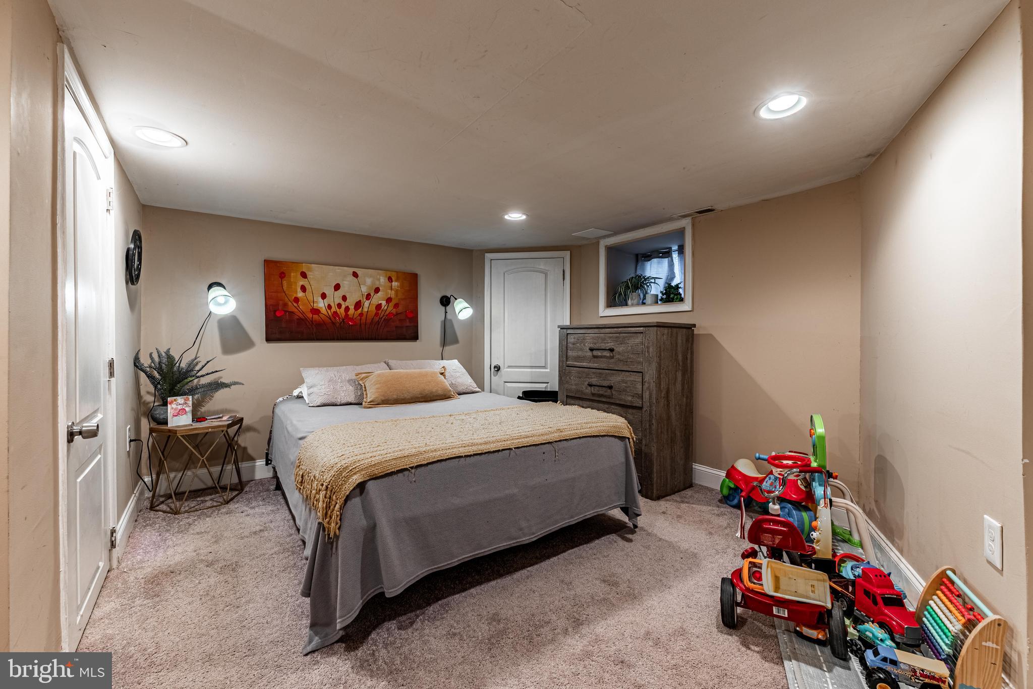 2600 Queen Anne Road Baltimore, MD 21216 - Photo 21 of 28 a bedroom with a bed and a couch