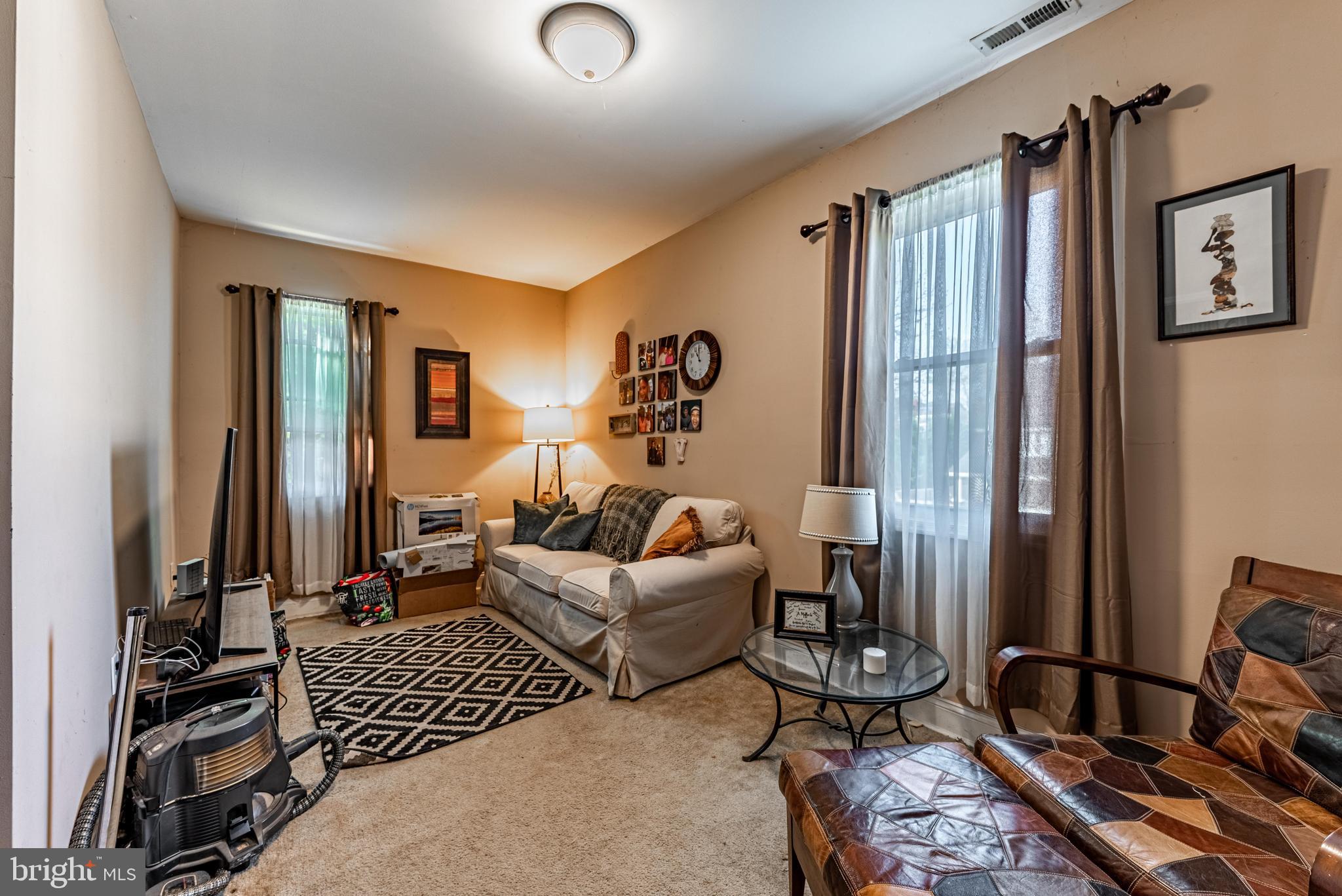 2600 Queen Anne Road Baltimore, MD 21216 - Photo 24 of 28 a living room with furniture and a flat screen tv