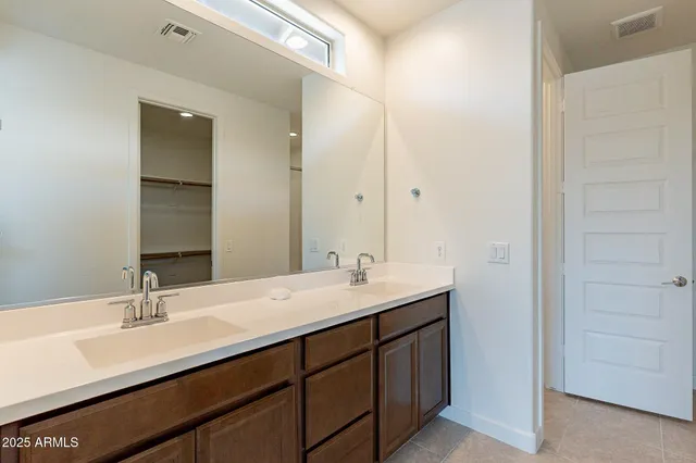 a bathroom with a sink double vanity and a mirror