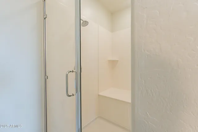 a bathroom with a glass shower door