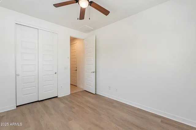 an empty room with a ceiling fan