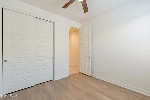 an empty room with ceiling fan