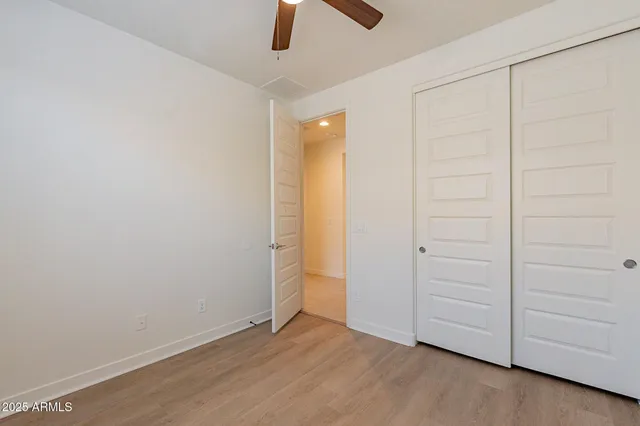 an empty room with ceiling fan