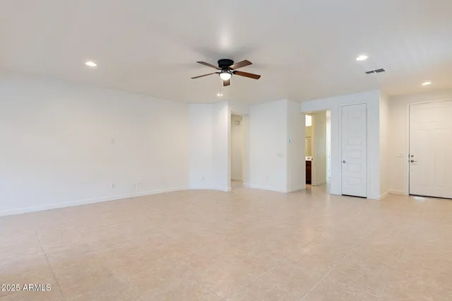 an empty room with fan and a ceiling fan