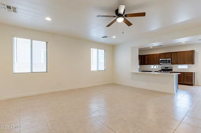 a view of kitchen with microwave and cabinets