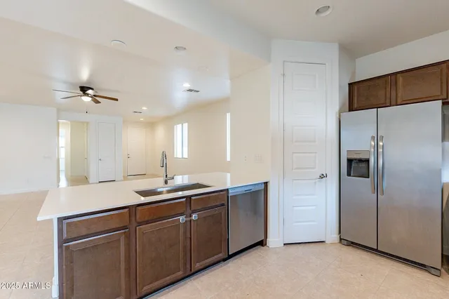 a kitchen with a sink and refrigerator