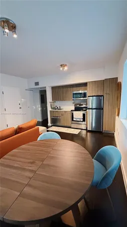 a room with furniture and a kitchen