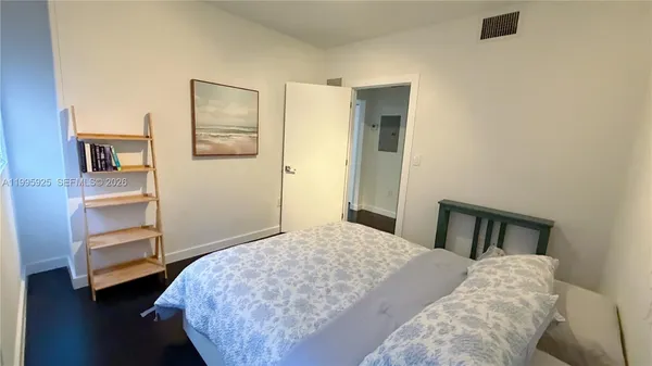 a bedroom with a bed and a cabinet