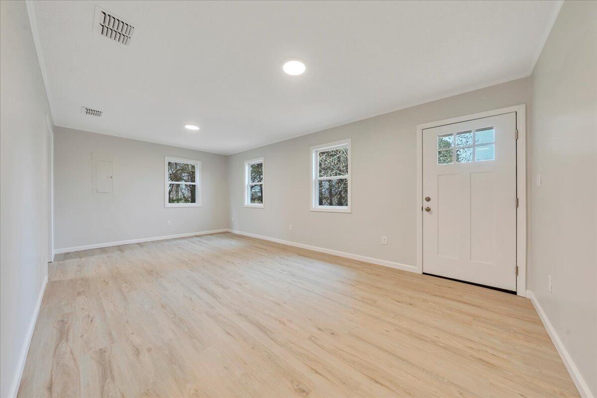 300 Ditto Branch Road Penhook, VA 24137 - Photo 2 of 29 a view of an empty room with wooden floor and a window